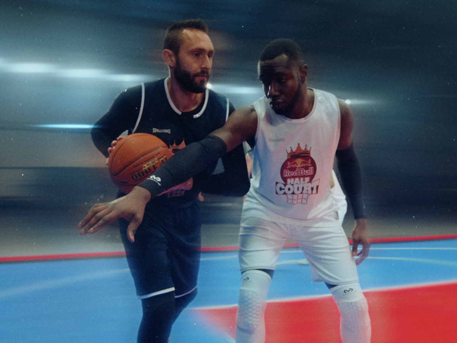 Two basketball players competing for the ball during a Red Bull 3x3 basketball training film