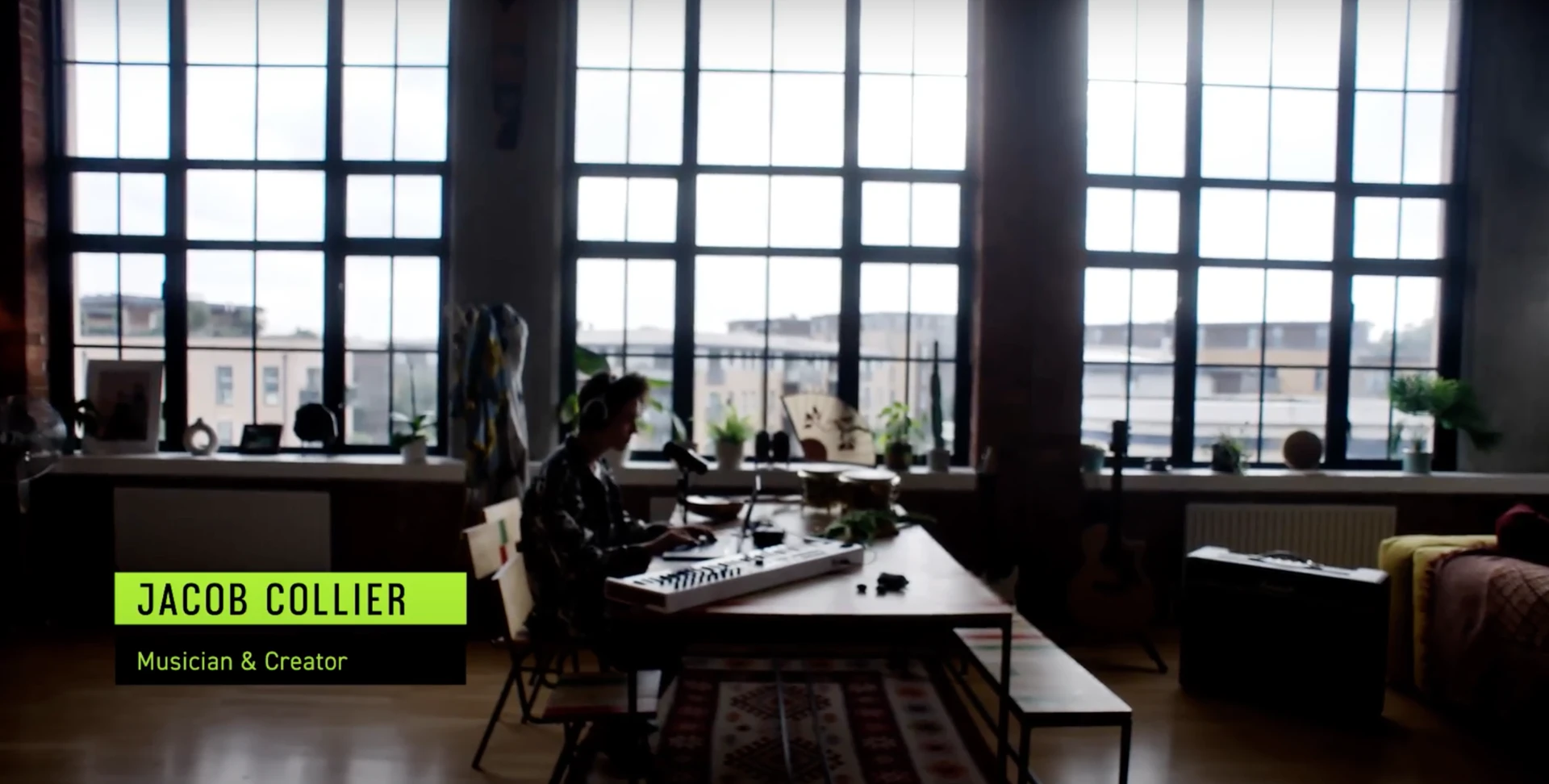 Wide view of Jacob Collier working at a keyboard in his daylit studio during the Shure campaign film