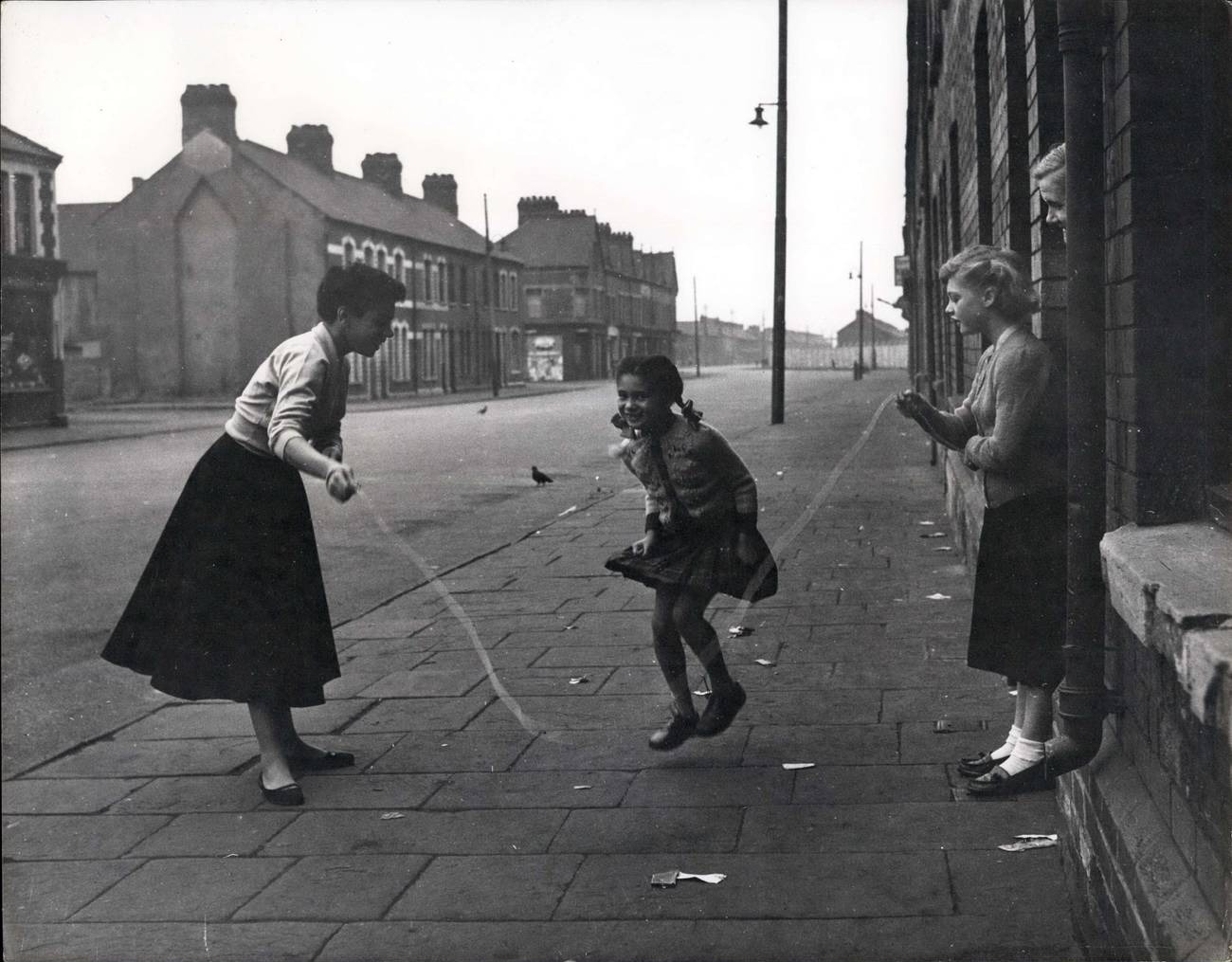 Black-and-white photograph of children playing in the street in Tiger Bay, Cardiff, 1955